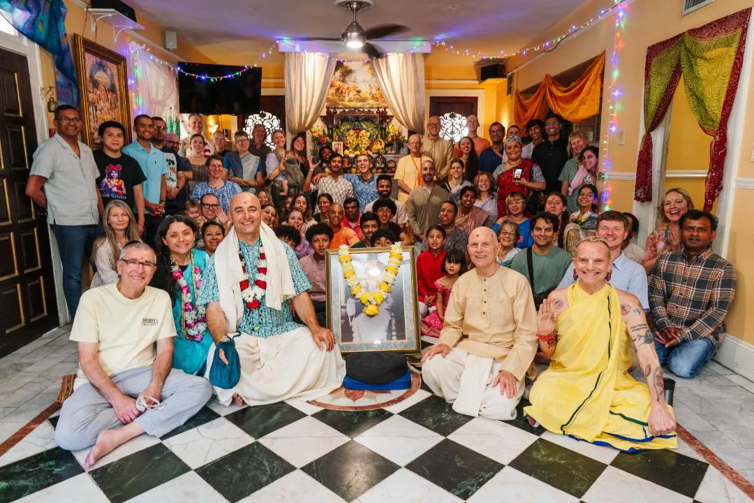 Krishna House community gathered together in the temple room
